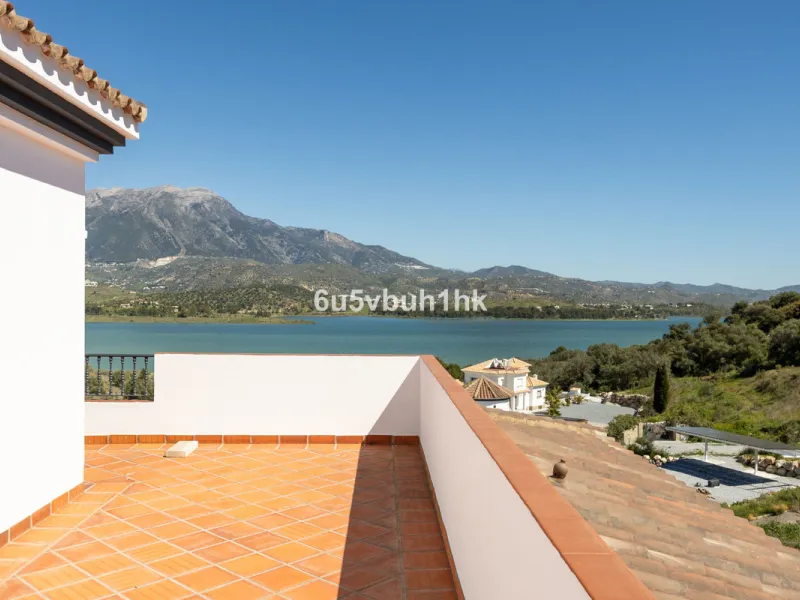 Some houses have a view. This one has a lake at its feet and a mountain range as its frame.