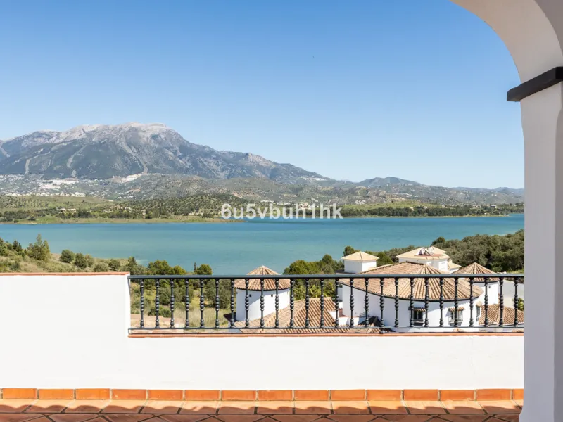Some houses have a view. This one has a lake at its feet and a mountain range as its frame.