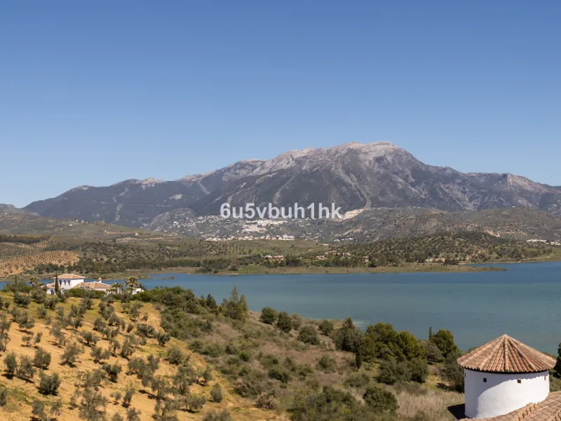 Some houses have a view. This one has a lake at its feet and a mountain range as its frame.