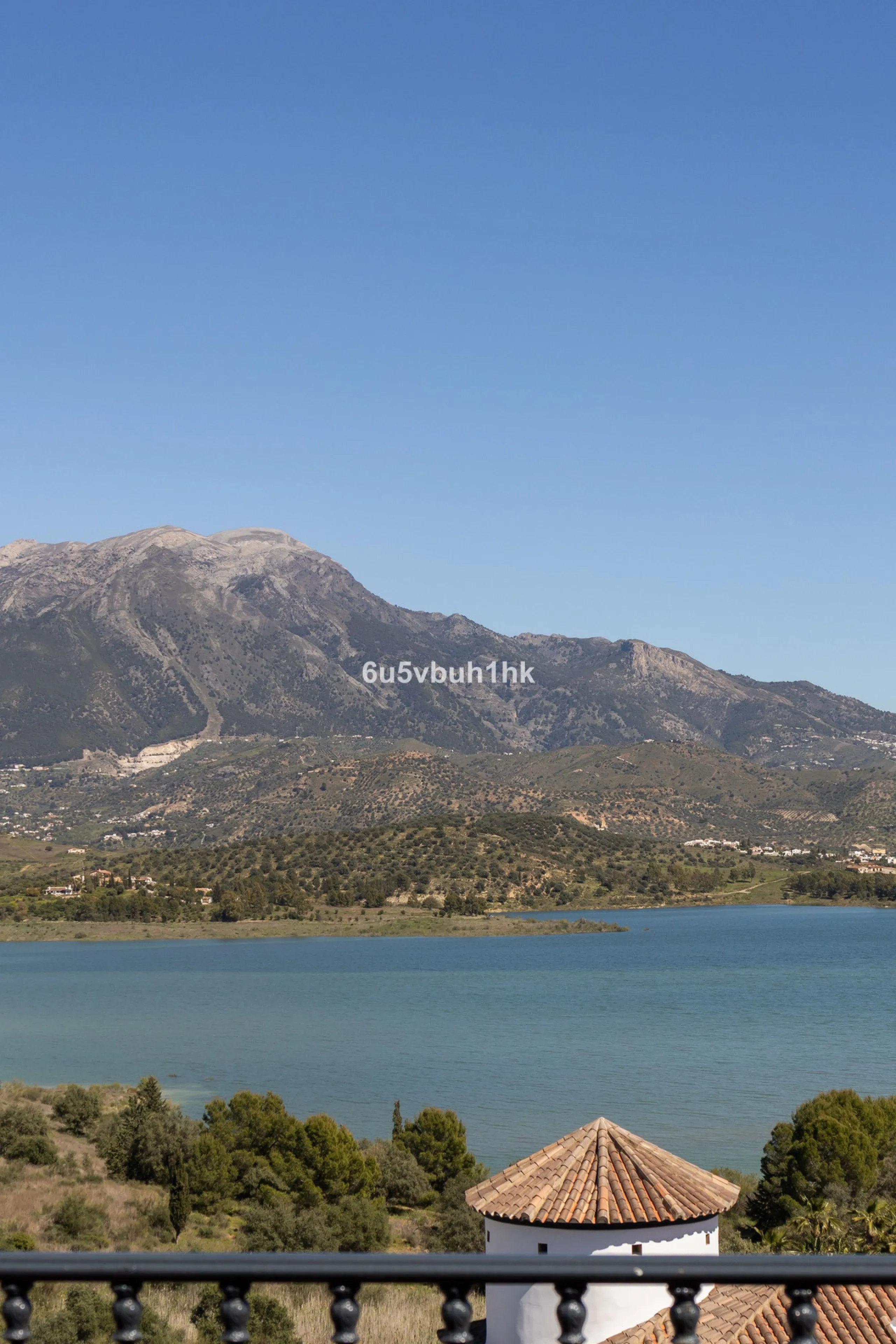 Some houses have a view. This one has a lake at its feet and a mountain range as its frame.