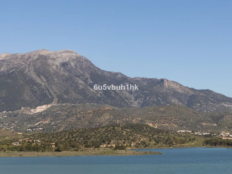 Some houses have a view. This one has a lake at its feet and a mountain range as its frame.