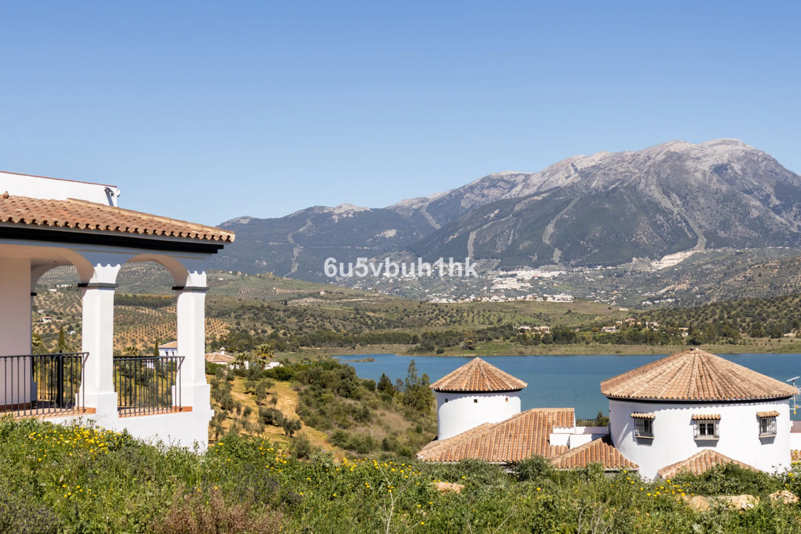 Some houses have a view. This one has a lake at its feet and a mountain range as its frame.
