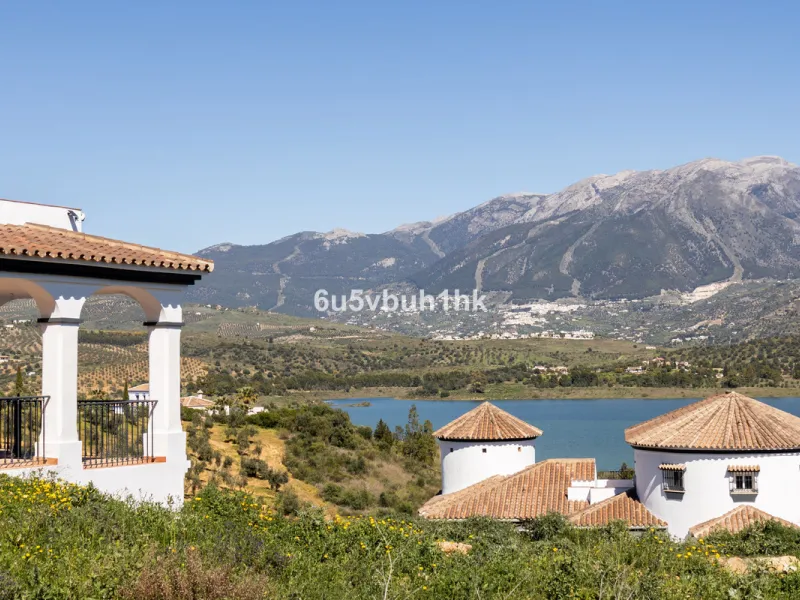 Some houses have a view. This one has a lake at its feet and a mountain range as its frame.
