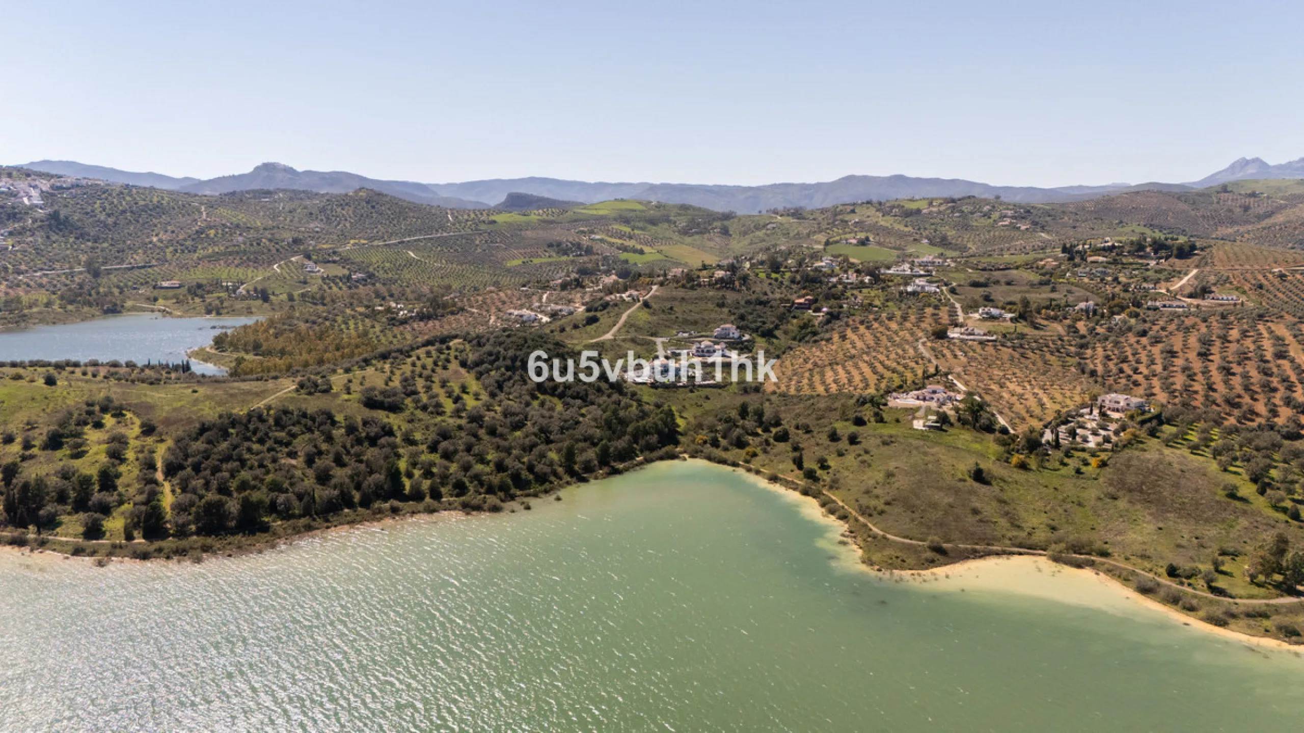 Some houses have a view. This one has a lake at its feet and a mountain range as its frame.