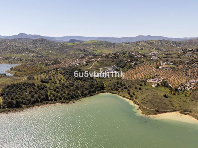 Some houses have a view. This one has a lake at its feet and a mountain range as its frame.