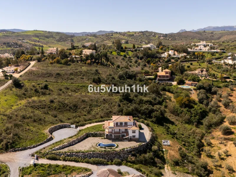 Some houses have a view. This one has a lake at its feet and a mountain range as its frame.