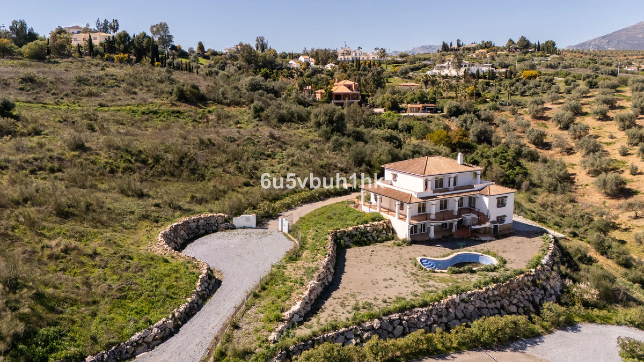 Some houses have a view. This one has a lake at its feet and a mountain range as its frame.
