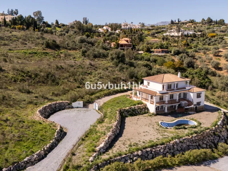 Some houses have a view. This one has a lake at its feet and a mountain range as its frame.