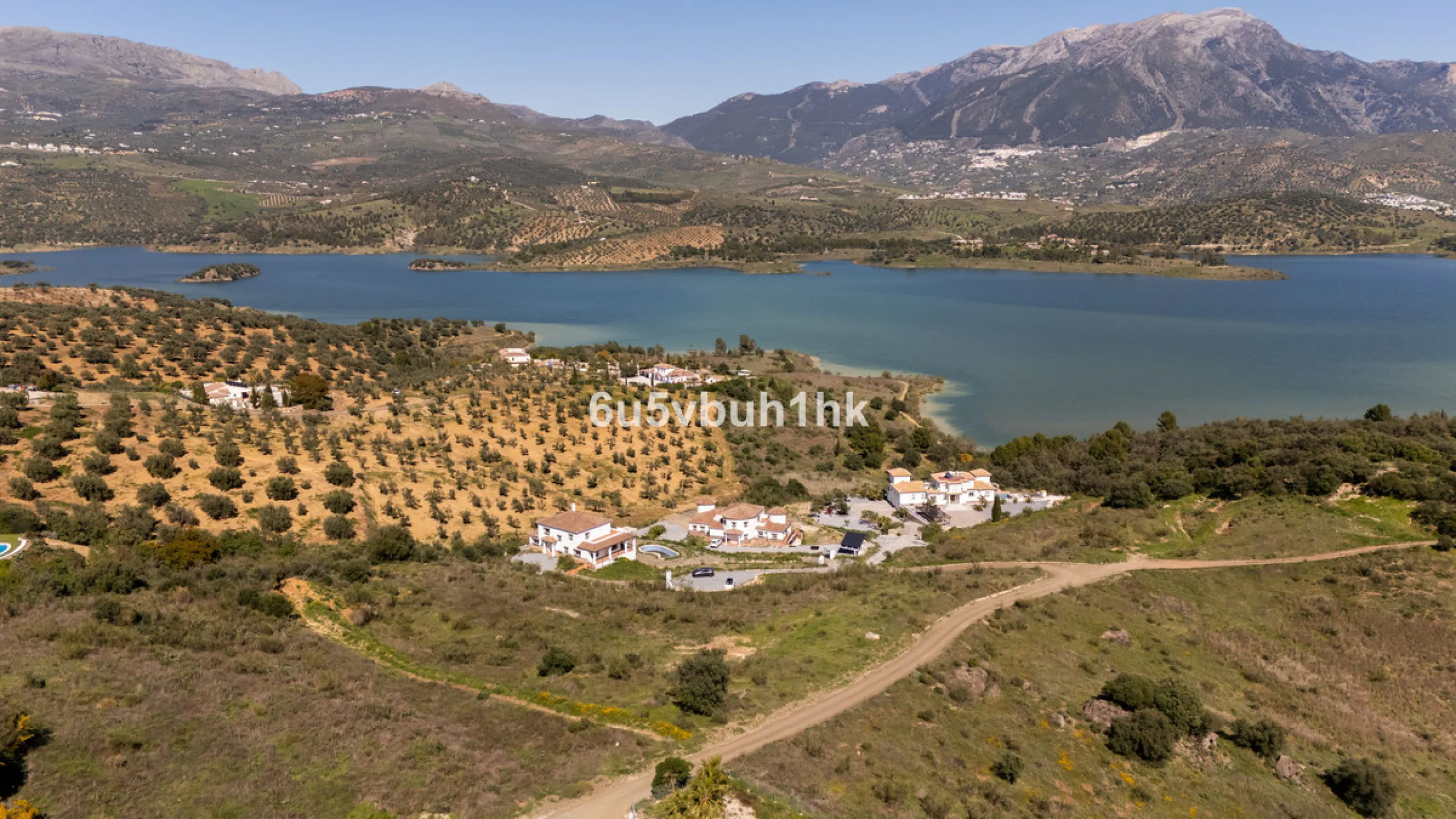 Some houses have a view. This one has a lake at its feet and a mountain range as its frame.