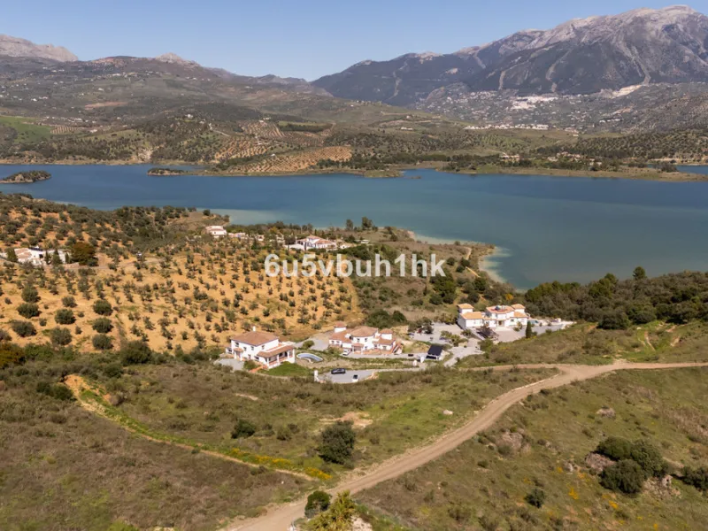 Some houses have a view. This one has a lake at its feet and a mountain range as its frame.