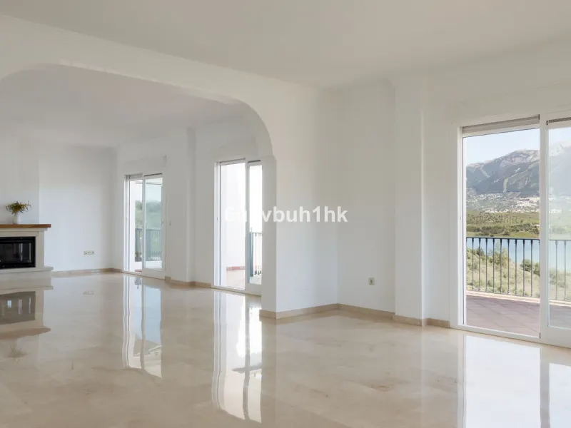 Some houses have a view. This one has a lake at its feet and a mountain range as its frame.