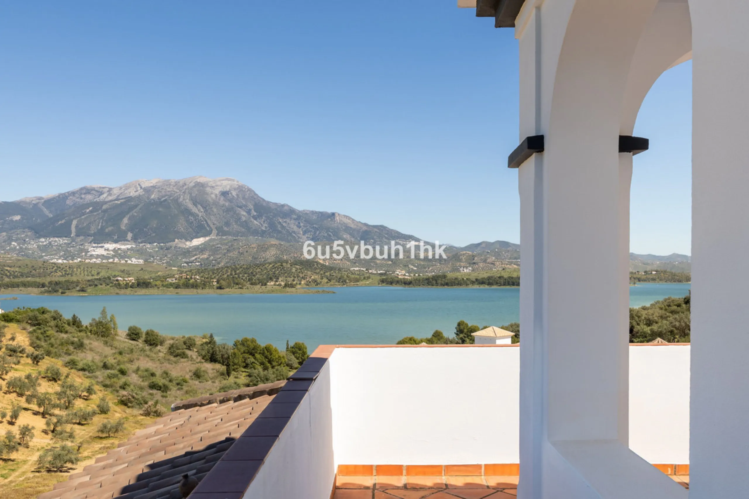 Some houses have a view. This one has a lake at its feet and a mountain range as its frame.