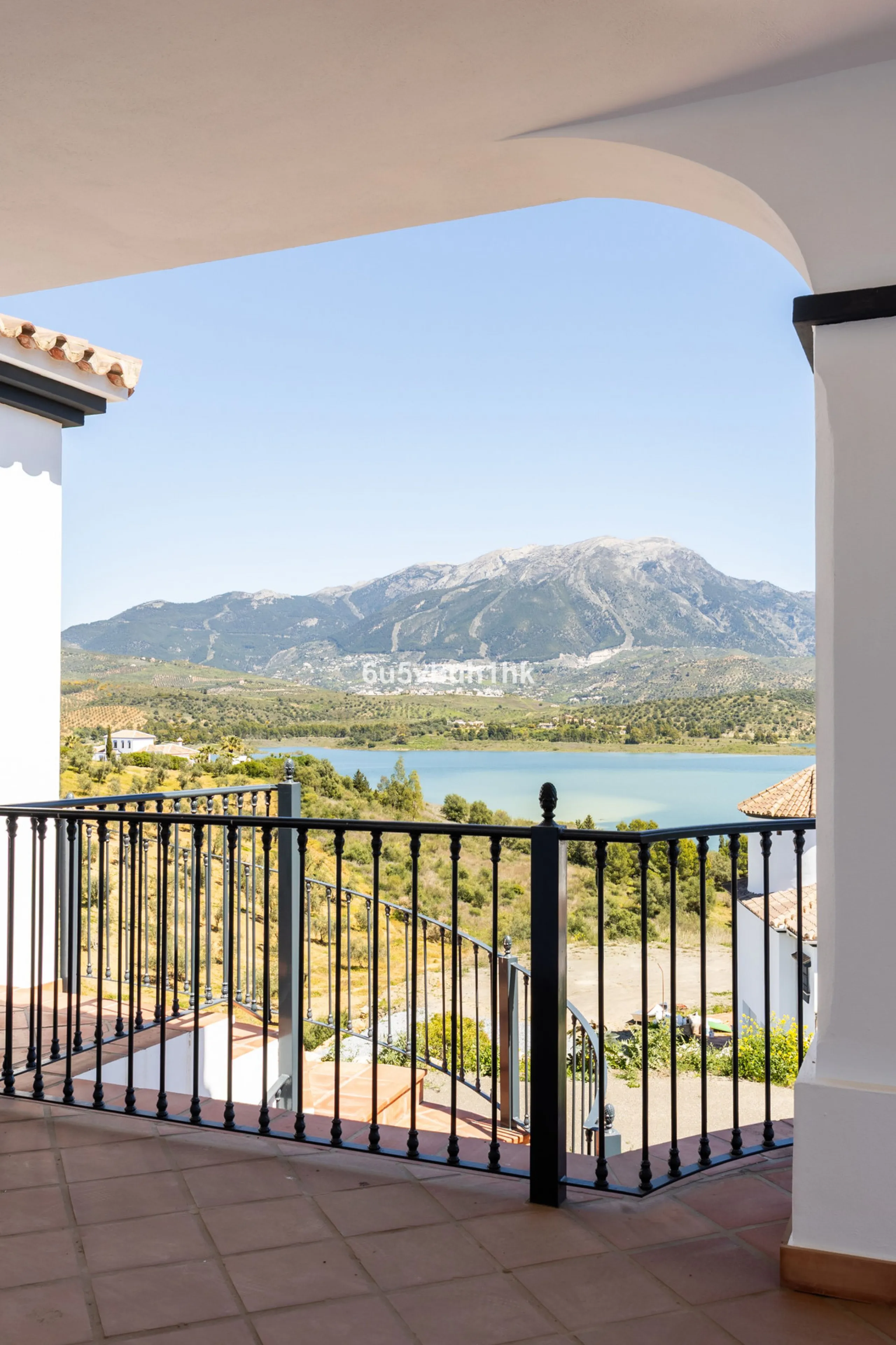 Some houses have a view. This one has a lake at its feet and a mountain range as its frame.