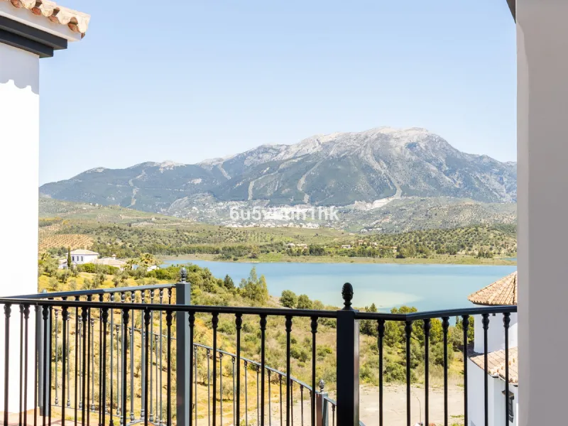Some houses have a view. This one has a lake at its feet and a mountain range as its frame.