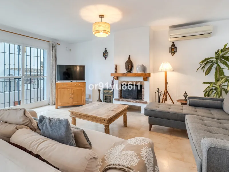 Townhouse Close to the Beach in Costabella Located within a gated, secure community in Costabella, just a short stroll from the beach, this three-bedroom, two-bathroom townhouse features a bright, spacious interior comprising a cosy living room with firep
