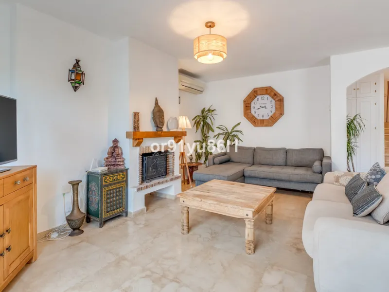 Townhouse Close to the Beach in Costabella Located within a gated, secure community in Costabella, just a short stroll from the beach, this three-bedroom, two-bathroom townhouse features a bright, spacious interior comprising a cosy living room with firep