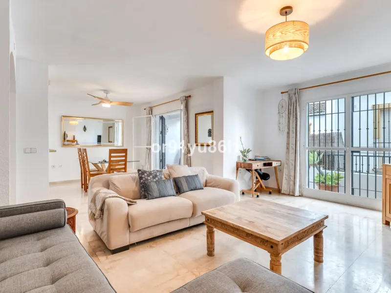 Townhouse Close to the Beach in Costabella Located within a gated, secure community in Costabella, just a short stroll from the beach, this three-bedroom, two-bathroom townhouse features a bright, spacious interior comprising a cosy living room with firep