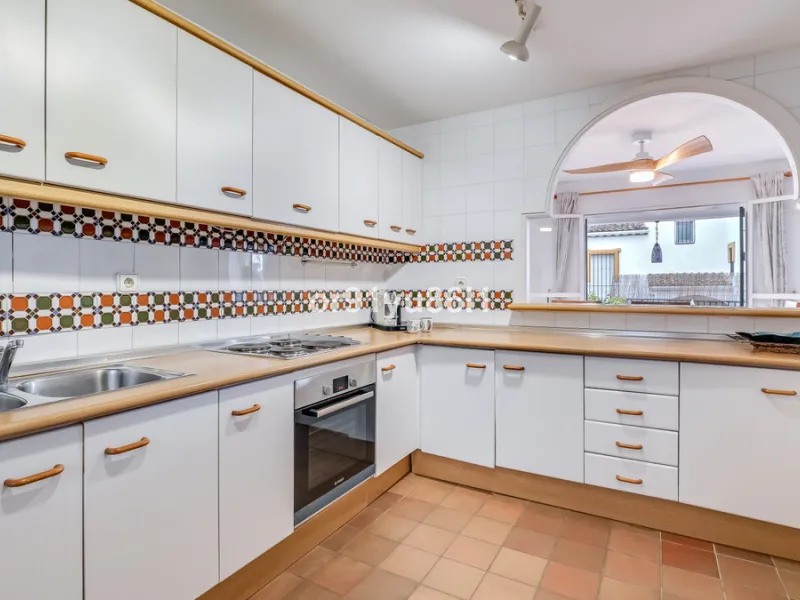 Townhouse Close to the Beach in Costabella Located within a gated, secure community in Costabella, just a short stroll from the beach, this three-bedroom, two-bathroom townhouse features a bright, spacious interior comprising a cosy living room with firep
