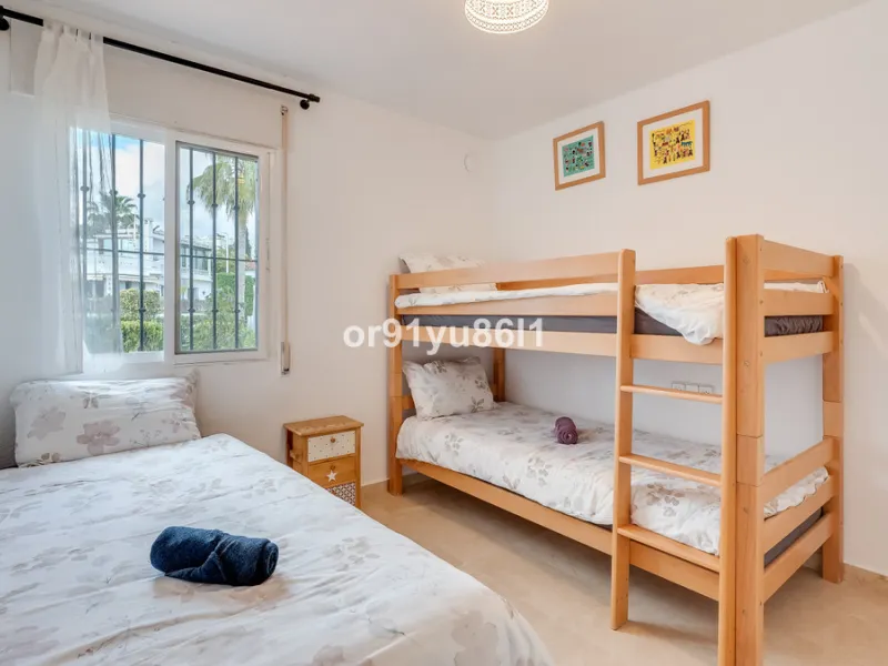 Townhouse Close to the Beach in Costabella Located within a gated, secure community in Costabella, just a short stroll from the beach, this three-bedroom, two-bathroom townhouse features a bright, spacious interior comprising a cosy living room with firep
