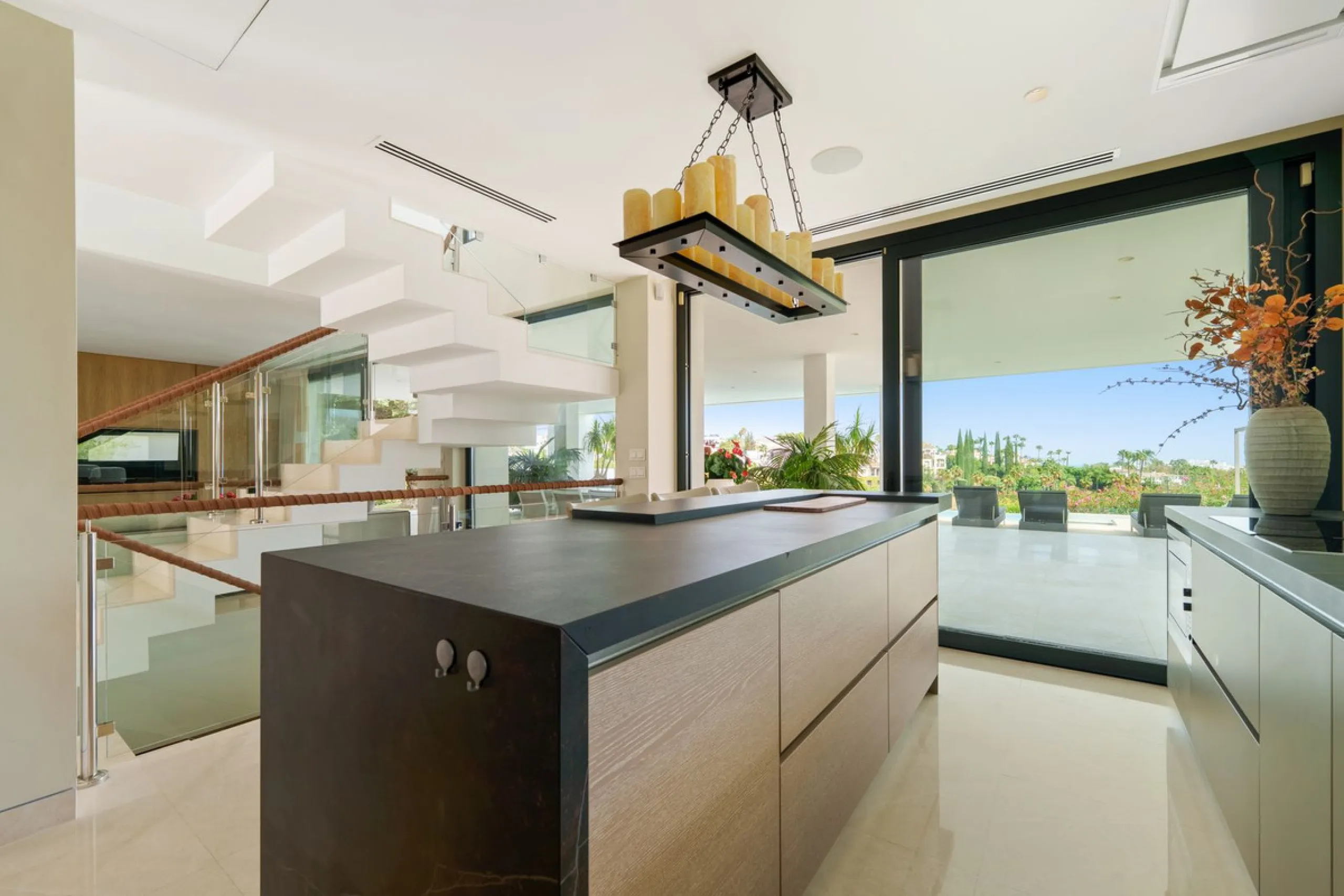 A striking contemporary villa in the heart of Nueva Andalucía, enjoying a privileged frontline golf position. With clean architectural lines, expansive terraces, and floor-to-ceiling windows, this home is designed to maximize natural light and uninterrupt