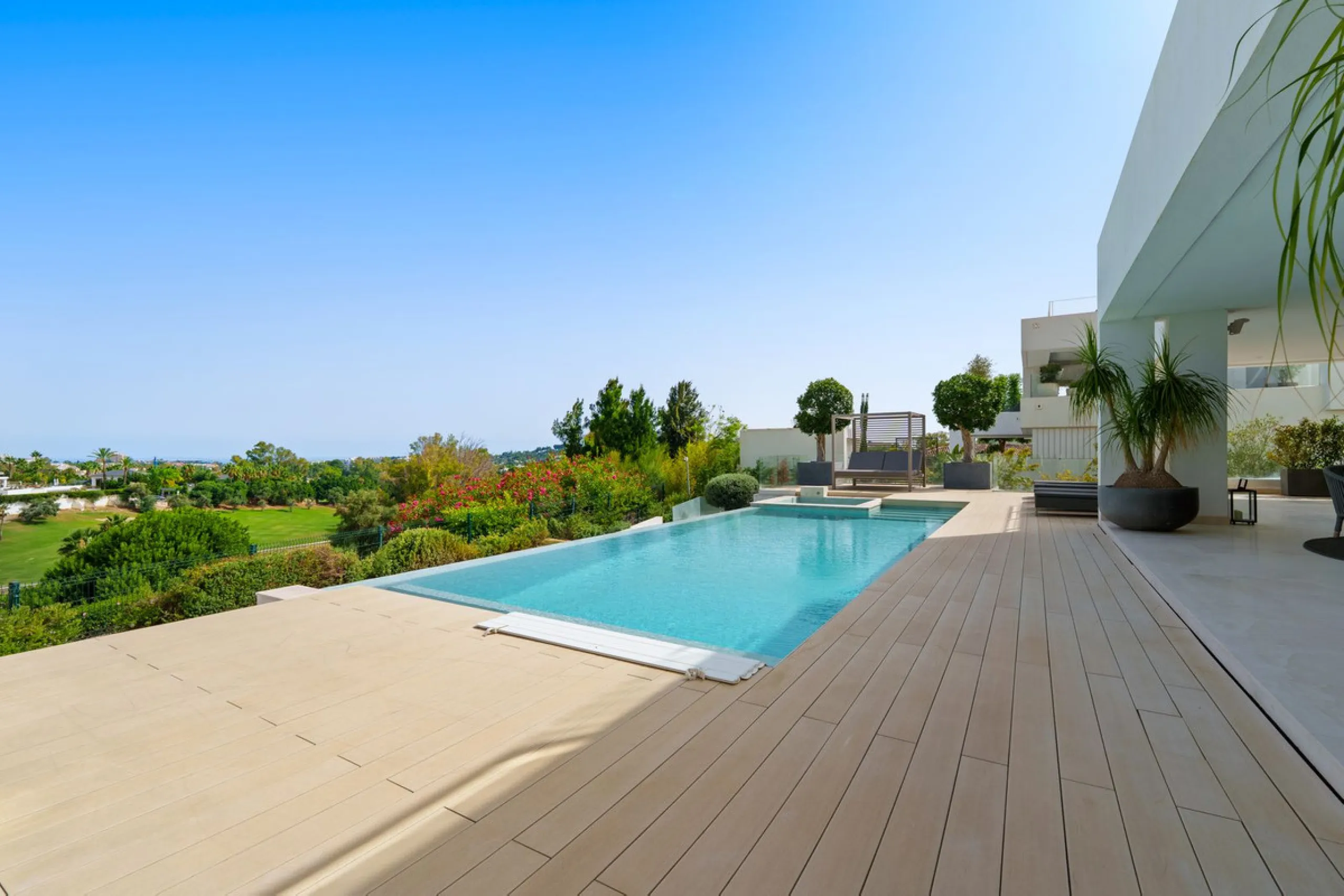A striking contemporary villa in the heart of Nueva Andalucía, enjoying a privileged frontline golf position. With clean architectural lines, expansive terraces, and floor-to-ceiling windows, this home is designed to maximize natural light and uninterrupt