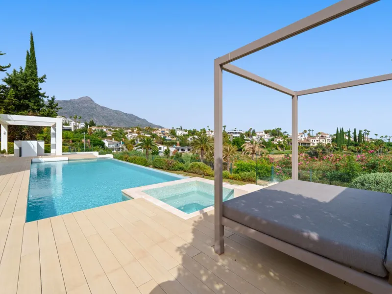 A striking contemporary villa in the heart of Nueva Andalucía, enjoying a privileged frontline golf position. With clean architectural lines, expansive terraces, and floor-to-ceiling windows, this home is designed to maximize natural light and uninterrupt