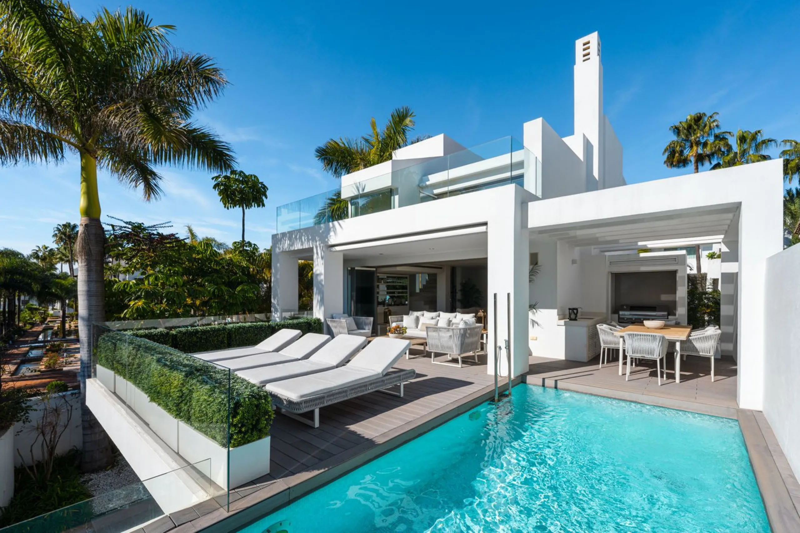 A semi-detached villa in the urbanisation, four bedrooms, four bathrooms, arranged with intent rather than habit: basement level below, an entrance floor with three en-suite bedrooms and a calm water feature setting the tone, a first floor dedicated entir