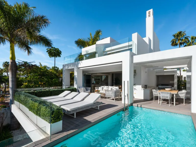 A semi-detached villa in the urbanisation, four bedrooms, four bathrooms, arranged with intent rather than habit: basement level below, an entrance floor with three en-suite bedrooms and a calm water feature setting the tone, a first floor dedicated entir