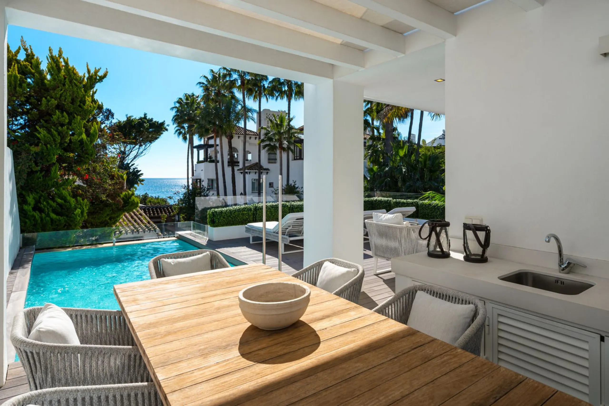 A semi-detached villa in the urbanisation, four bedrooms, four bathrooms, arranged with intent rather than habit: basement level below, an entrance floor with three en-suite bedrooms and a calm water feature setting the tone, a first floor dedicated entir