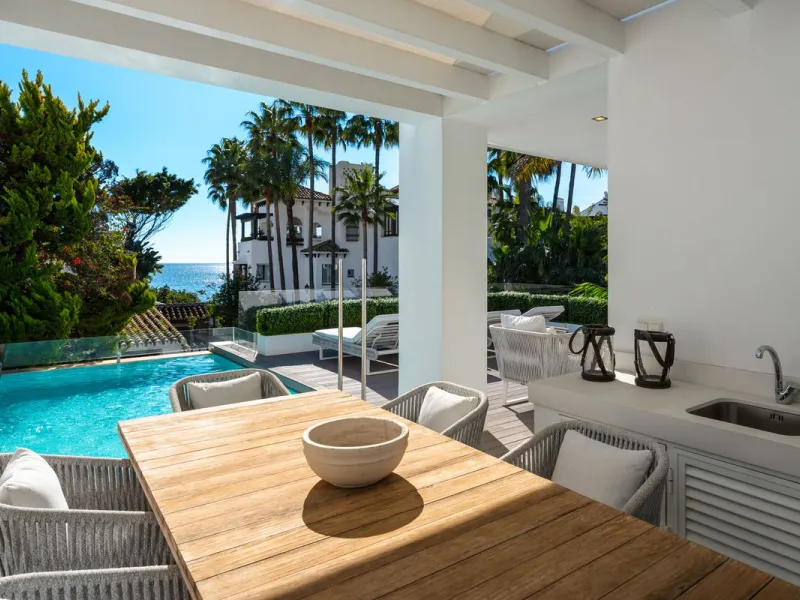 A semi-detached villa in the urbanisation, four bedrooms, four bathrooms, arranged with intent rather than habit: basement level below, an entrance floor with three en-suite bedrooms and a calm water feature setting the tone, a first floor dedicated entir