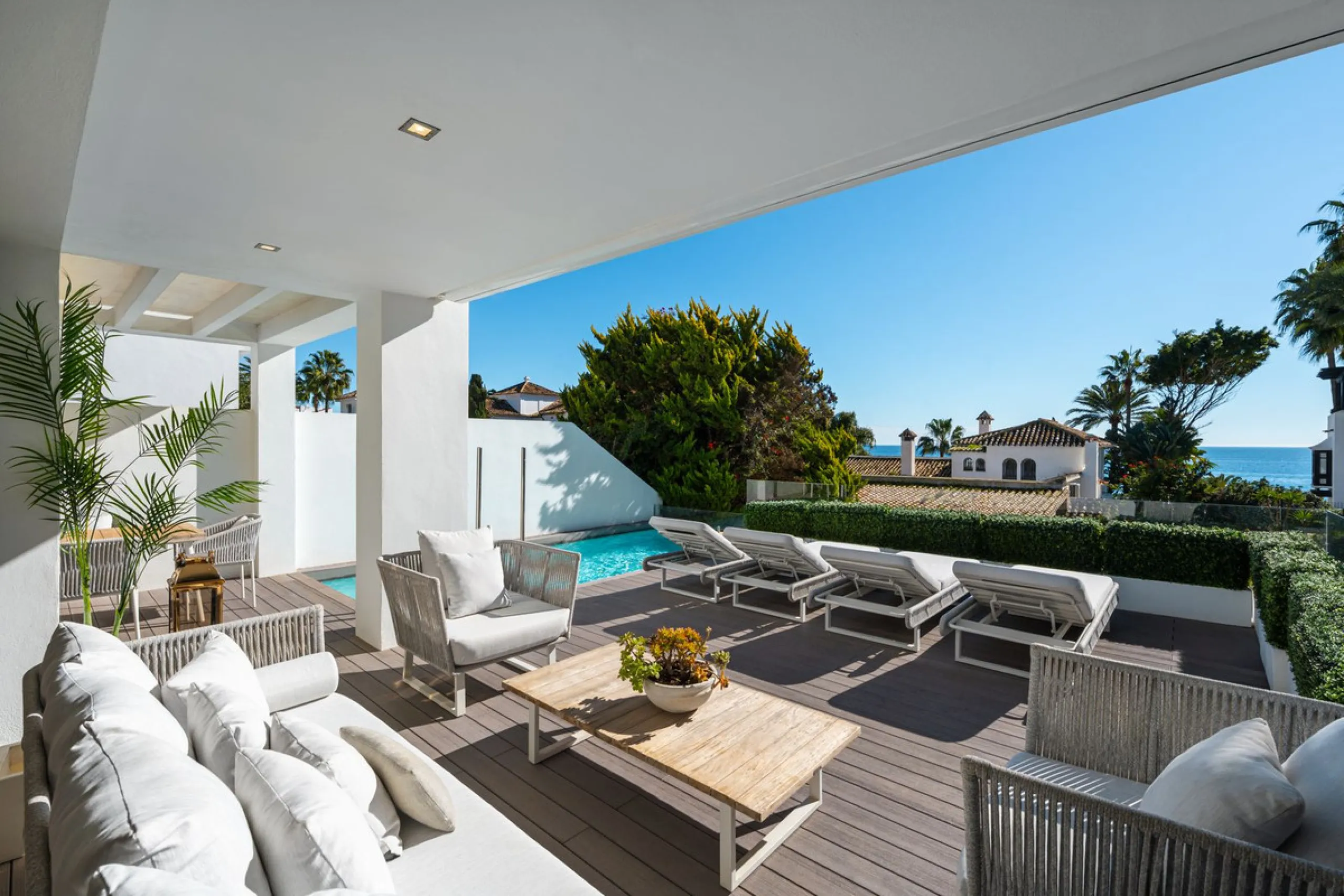 A semi-detached villa in the urbanisation, four bedrooms, four bathrooms, arranged with intent rather than habit: basement level below, an entrance floor with three en-suite bedrooms and a calm water feature setting the tone, a first floor dedicated entir