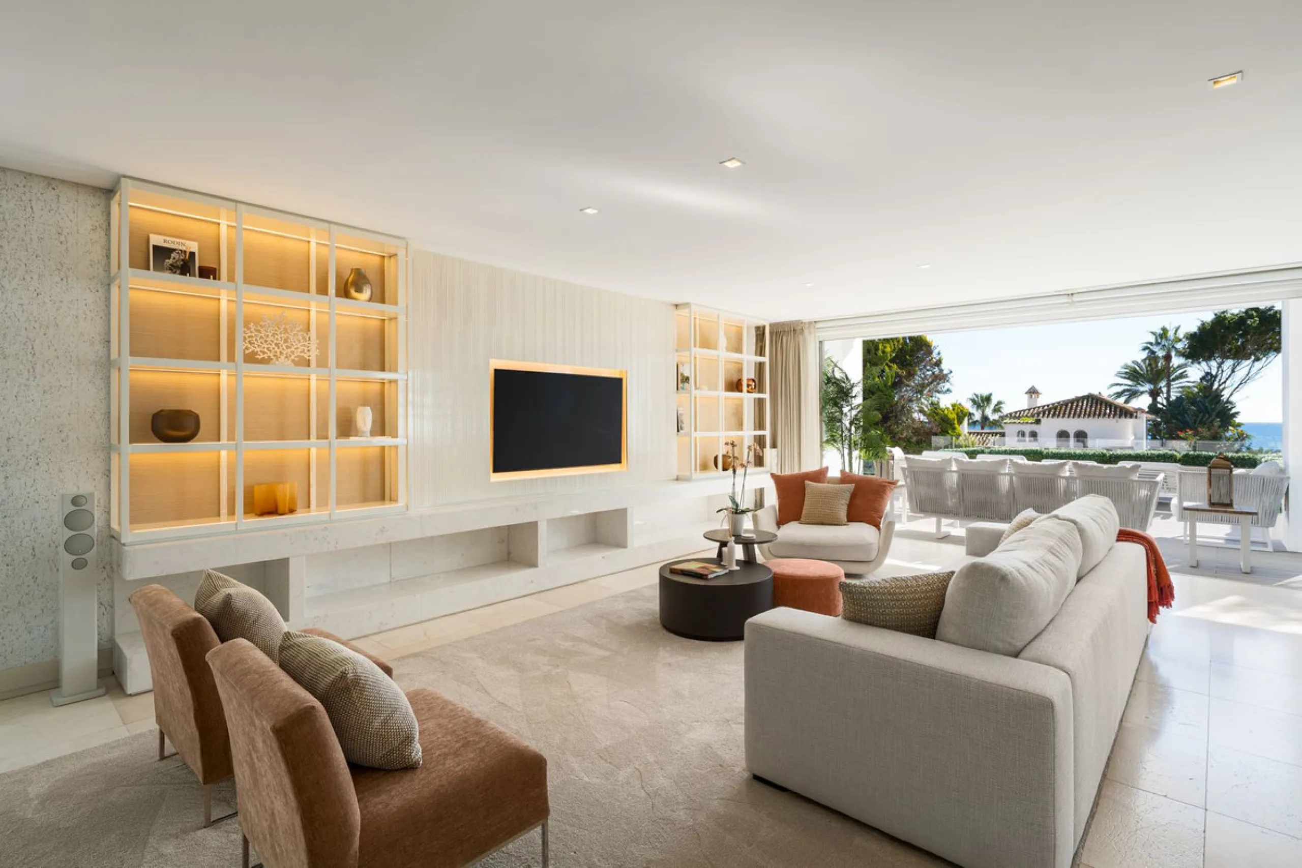 A semi-detached villa in the urbanisation, four bedrooms, four bathrooms, arranged with intent rather than habit: basement level below, an entrance floor with three en-suite bedrooms and a calm water feature setting the tone, a first floor dedicated entir