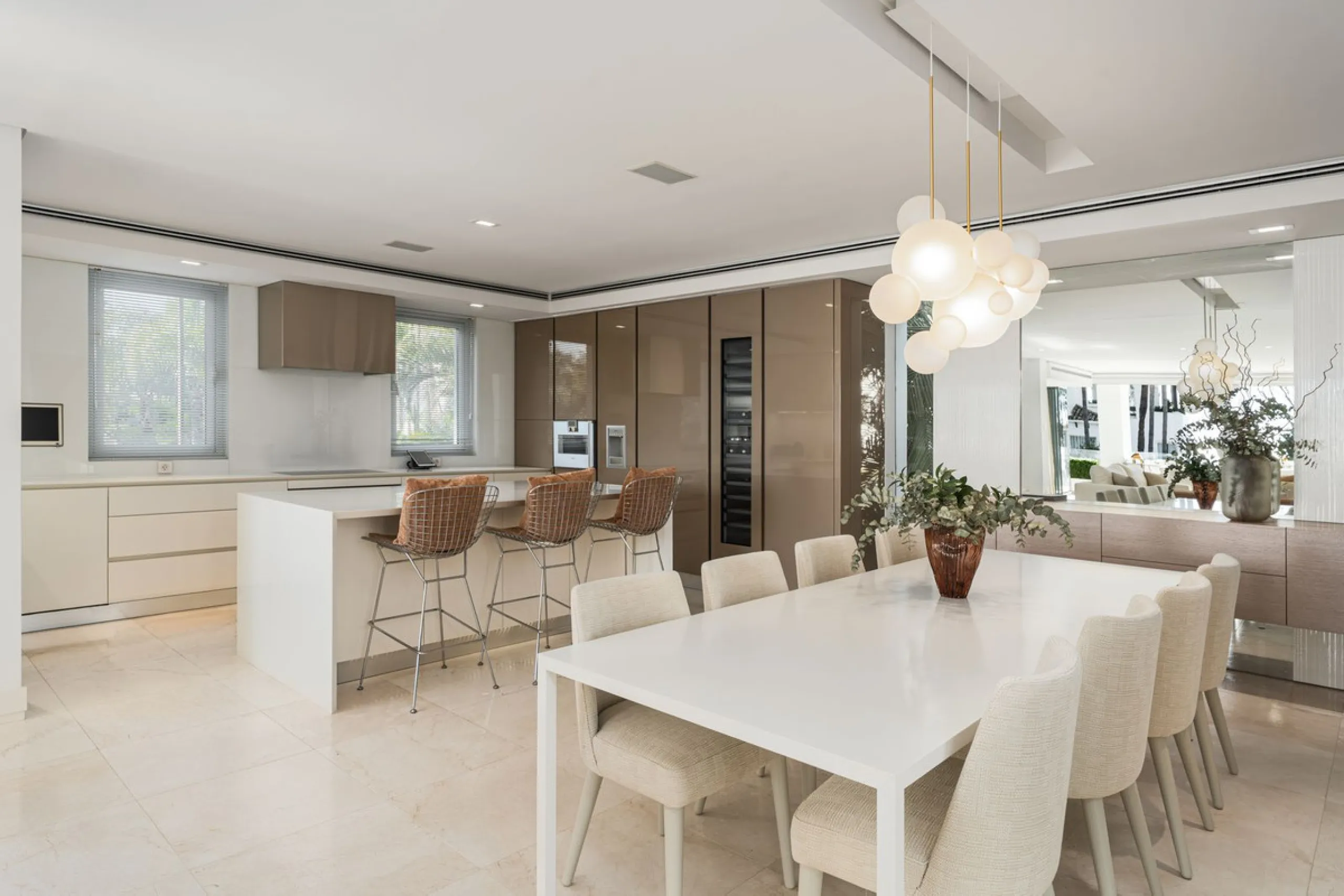 A semi-detached villa in the urbanisation, four bedrooms, four bathrooms, arranged with intent rather than habit: basement level below, an entrance floor with three en-suite bedrooms and a calm water feature setting the tone, a first floor dedicated entir