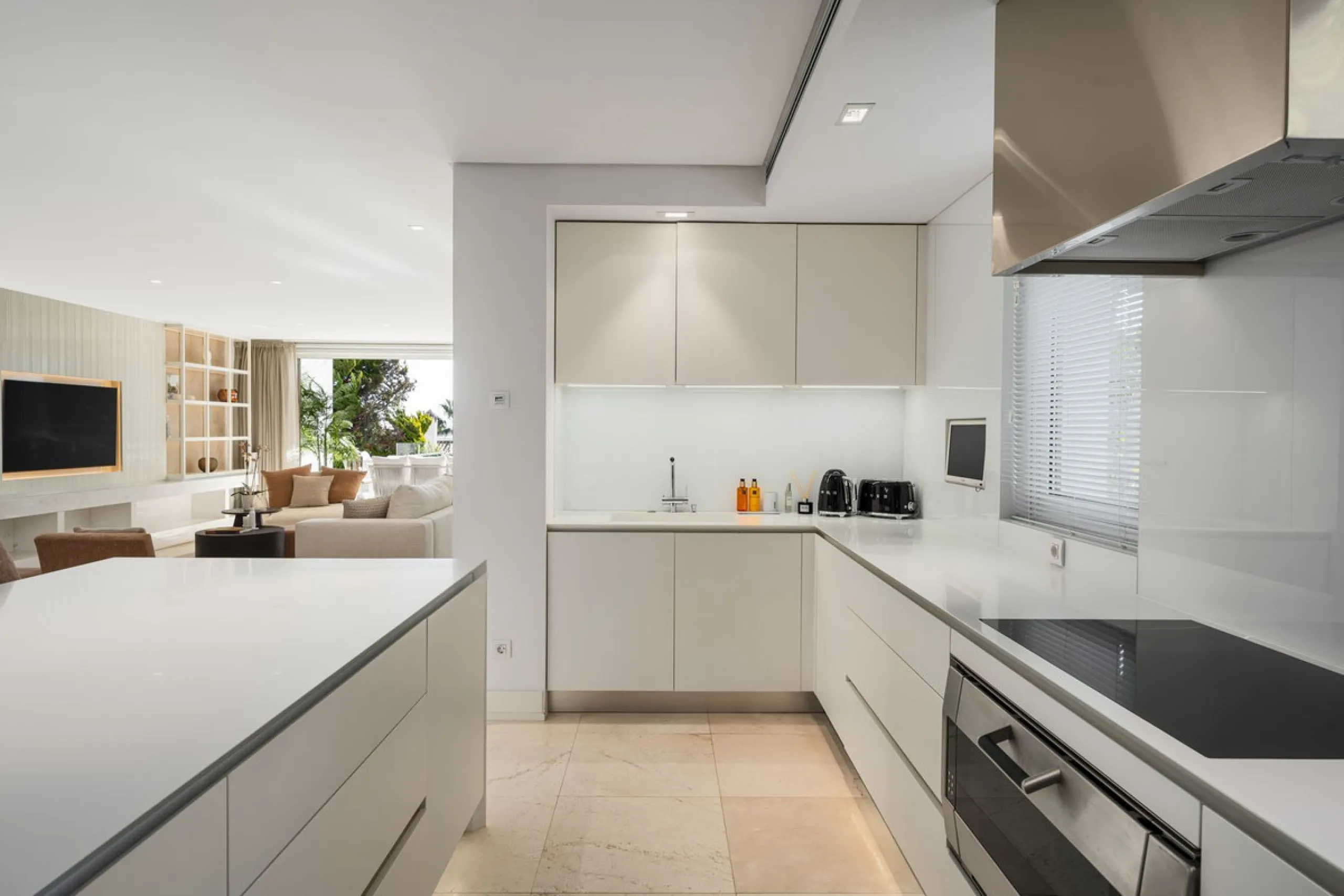 A semi-detached villa in the urbanisation, four bedrooms, four bathrooms, arranged with intent rather than habit: basement level below, an entrance floor with three en-suite bedrooms and a calm water feature setting the tone, a first floor dedicated entir