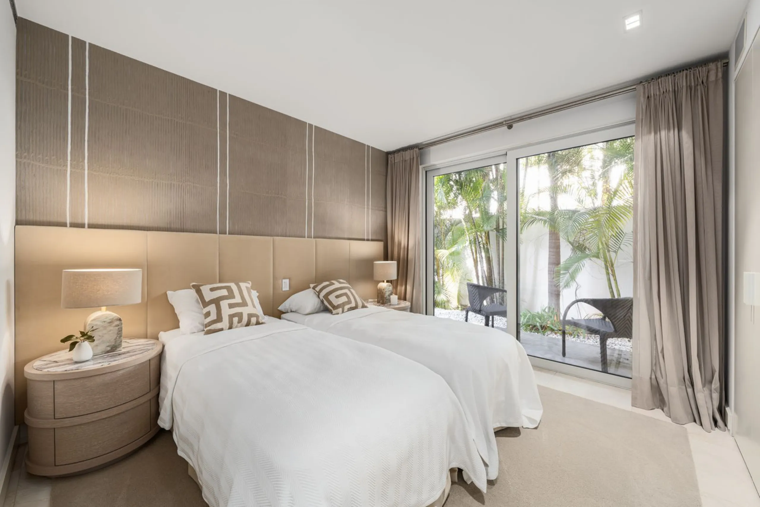 A semi-detached villa in the urbanisation, four bedrooms, four bathrooms, arranged with intent rather than habit: basement level below, an entrance floor with three en-suite bedrooms and a calm water feature setting the tone, a first floor dedicated entir