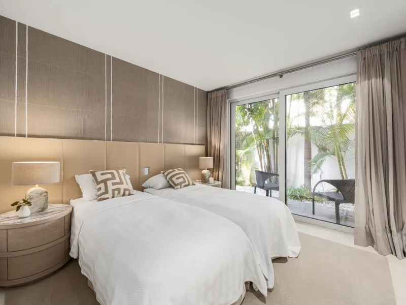 A semi-detached villa in the urbanisation, four bedrooms, four bathrooms, arranged with intent rather than habit: basement level below, an entrance floor with three en-suite bedrooms and a calm water feature setting the tone, a first floor dedicated entir
