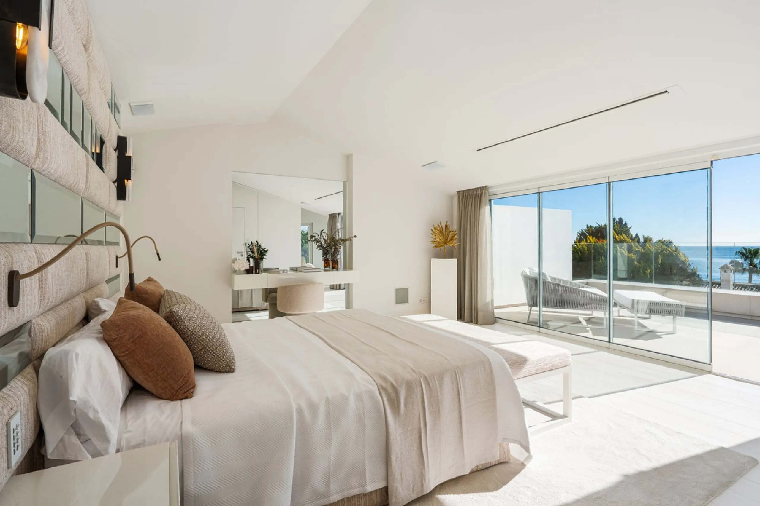 A semi-detached villa in the urbanisation, four bedrooms, four bathrooms, arranged with intent rather than habit: basement level below, an entrance floor with three en-suite bedrooms and a calm water feature setting the tone, a first floor dedicated entir