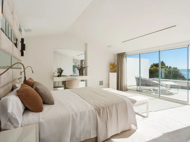 A semi-detached villa in the urbanisation, four bedrooms, four bathrooms, arranged with intent rather than habit: basement level below, an entrance floor with three en-suite bedrooms and a calm water feature setting the tone, a first floor dedicated entir