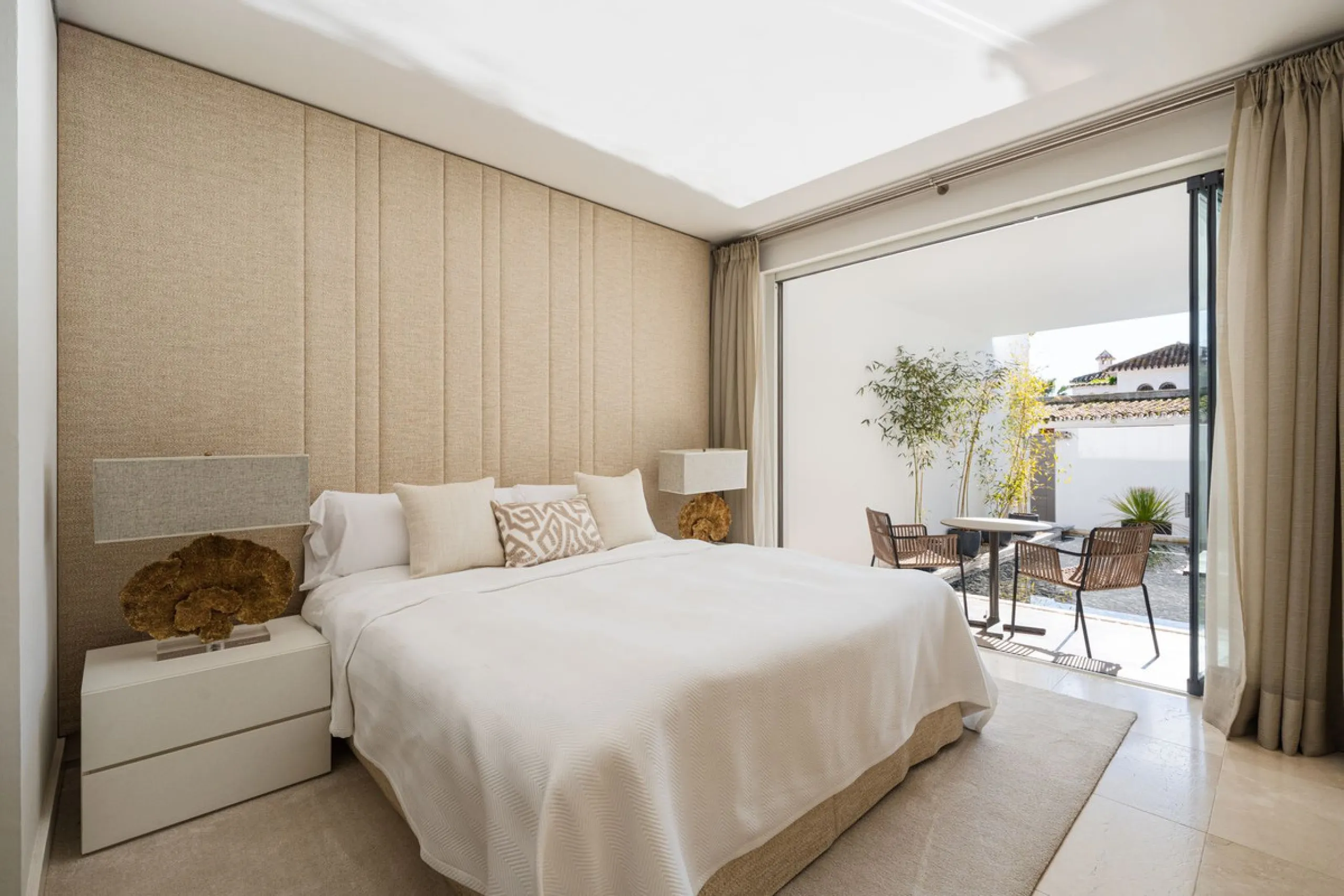A semi-detached villa in the urbanisation, four bedrooms, four bathrooms, arranged with intent rather than habit: basement level below, an entrance floor with three en-suite bedrooms and a calm water feature setting the tone, a first floor dedicated entir