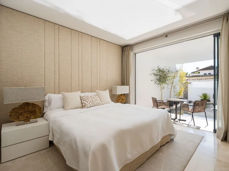 A semi-detached villa in the urbanisation, four bedrooms, four bathrooms, arranged with intent rather than habit: basement level below, an entrance floor with three en-suite bedrooms and a calm water feature setting the tone, a first floor dedicated entir