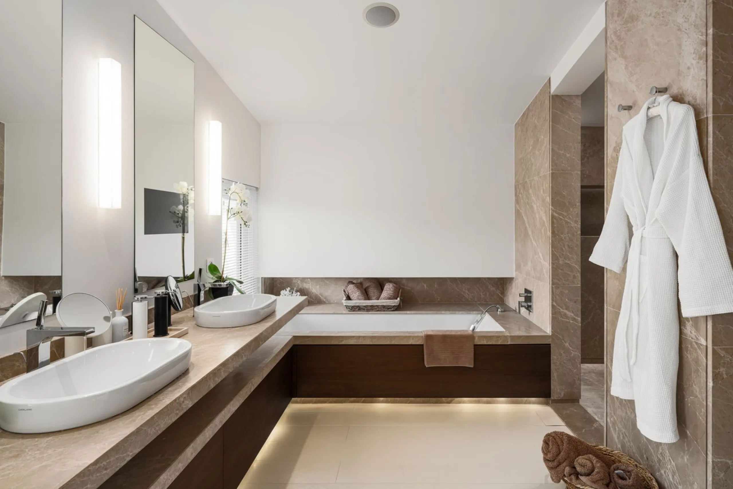 A semi-detached villa in the urbanisation, four bedrooms, four bathrooms, arranged with intent rather than habit: basement level below, an entrance floor with three en-suite bedrooms and a calm water feature setting the tone, a first floor dedicated entir