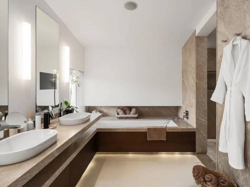 A semi-detached villa in the urbanisation, four bedrooms, four bathrooms, arranged with intent rather than habit: basement level below, an entrance floor with three en-suite bedrooms and a calm water feature setting the tone, a first floor dedicated entir