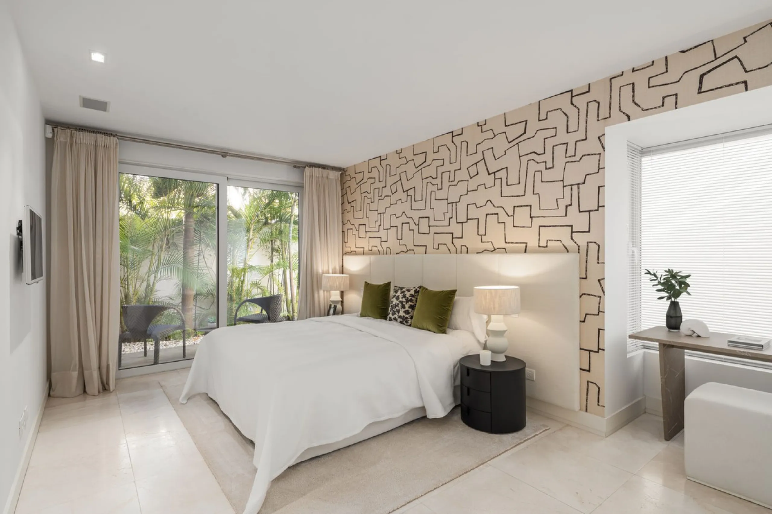 A semi-detached villa in the urbanisation, four bedrooms, four bathrooms, arranged with intent rather than habit: basement level below, an entrance floor with three en-suite bedrooms and a calm water feature setting the tone, a first floor dedicated entir