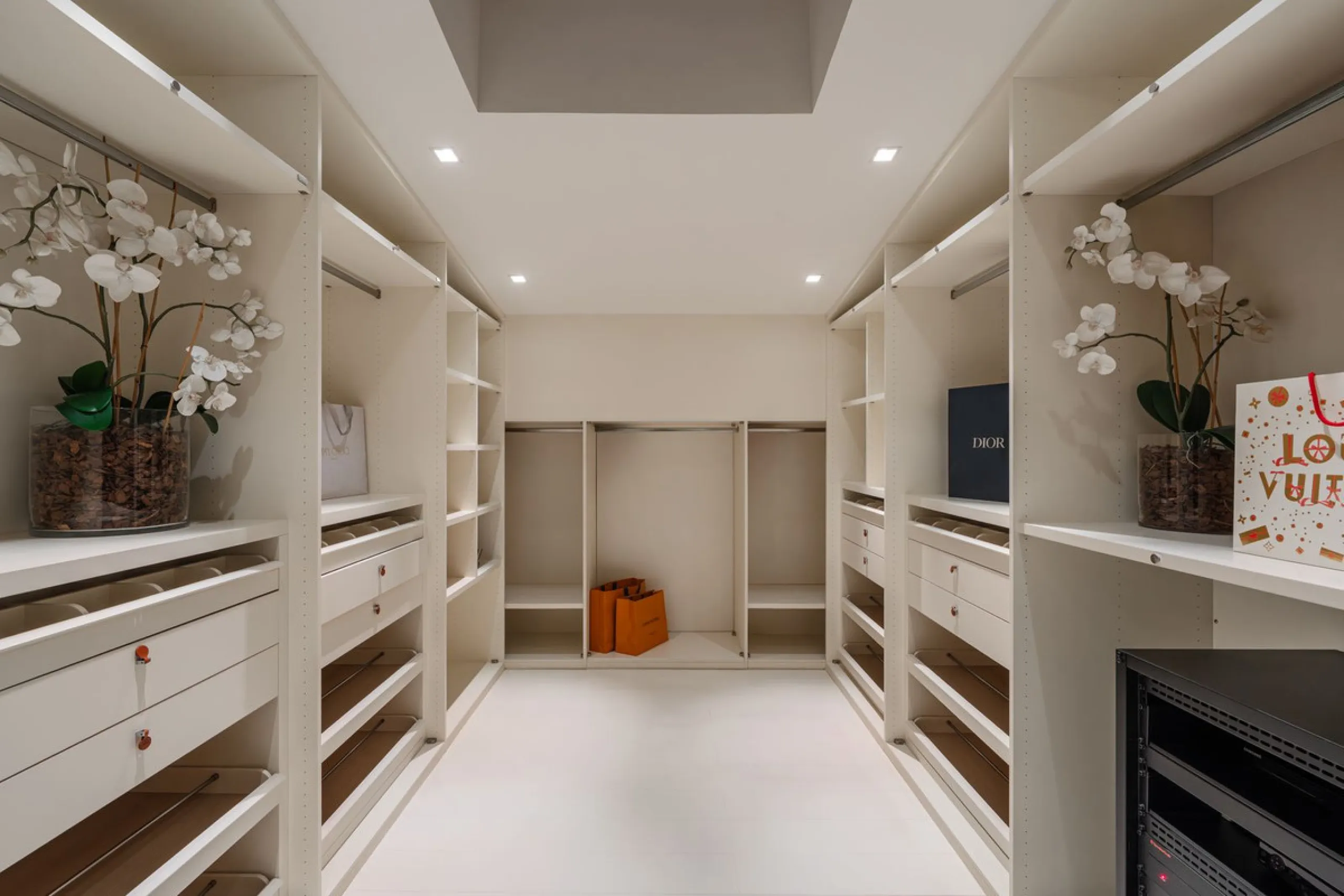 A semi-detached villa in the urbanisation, four bedrooms, four bathrooms, arranged with intent rather than habit: basement level below, an entrance floor with three en-suite bedrooms and a calm water feature setting the tone, a first floor dedicated entir