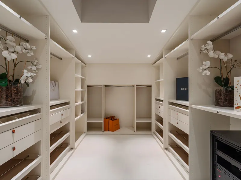 A semi-detached villa in the urbanisation, four bedrooms, four bathrooms, arranged with intent rather than habit: basement level below, an entrance floor with three en-suite bedrooms and a calm water feature setting the tone, a first floor dedicated entir