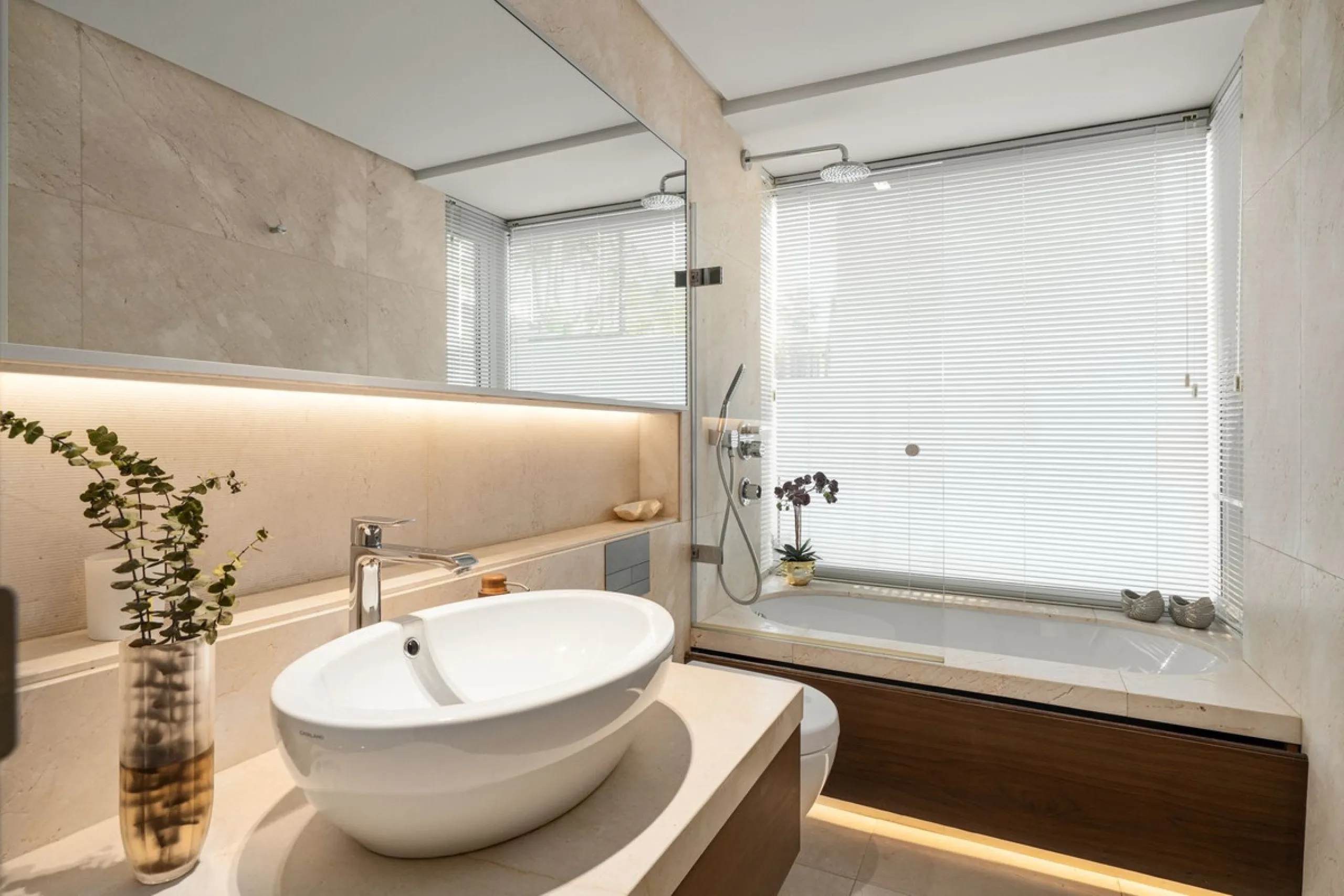 A semi-detached villa in the urbanisation, four bedrooms, four bathrooms, arranged with intent rather than habit: basement level below, an entrance floor with three en-suite bedrooms and a calm water feature setting the tone, a first floor dedicated entir