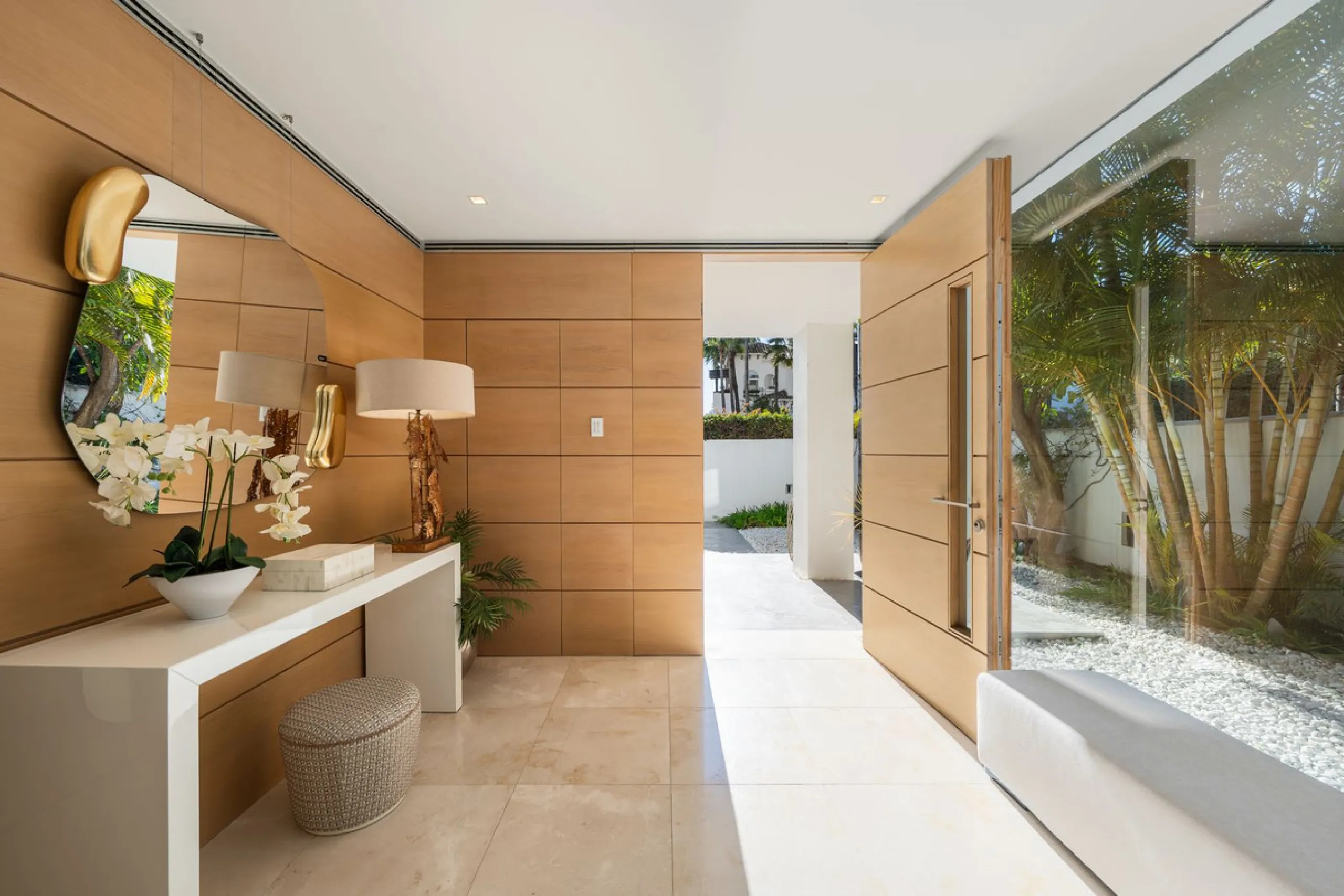 A semi-detached villa in the urbanisation, four bedrooms, four bathrooms, arranged with intent rather than habit: basement level below, an entrance floor with three en-suite bedrooms and a calm water feature setting the tone, a first floor dedicated entir