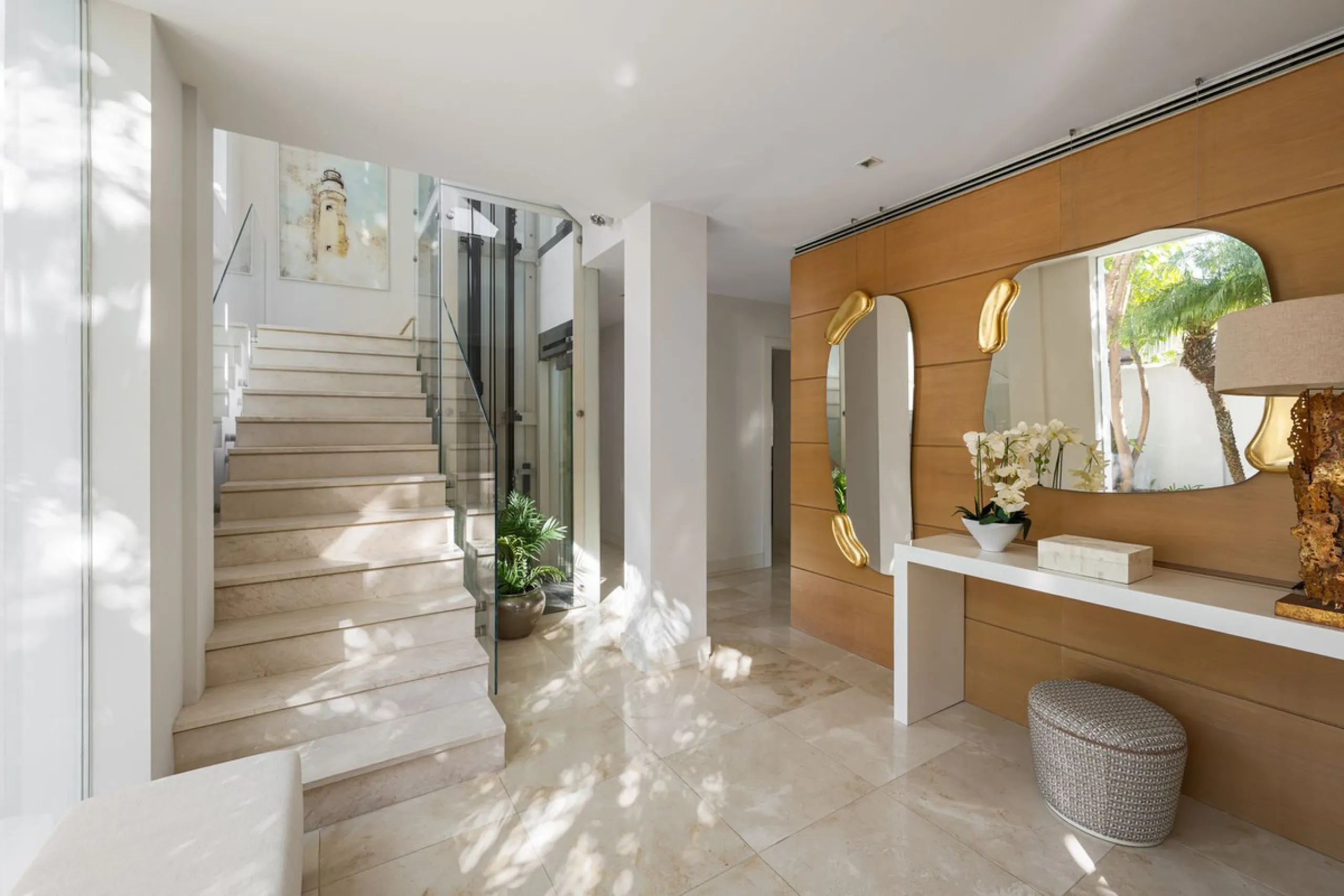 A semi-detached villa in the urbanisation, four bedrooms, four bathrooms, arranged with intent rather than habit: basement level below, an entrance floor with three en-suite bedrooms and a calm water feature setting the tone, a first floor dedicated entir