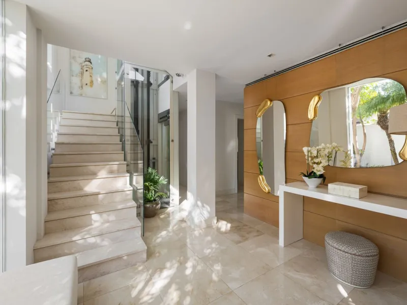 A semi-detached villa in the urbanisation, four bedrooms, four bathrooms, arranged with intent rather than habit: basement level below, an entrance floor with three en-suite bedrooms and a calm water feature setting the tone, a first floor dedicated entir