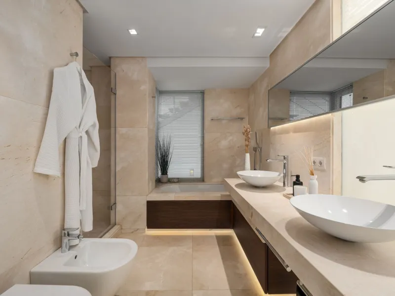 A semi-detached villa in the urbanisation, four bedrooms, four bathrooms, arranged with intent rather than habit: basement level below, an entrance floor with three en-suite bedrooms and a calm water feature setting the tone, a first floor dedicated entir